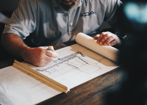 A man writing on a piece of paper.
