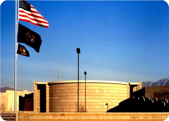 A few flags flying in front of a building.