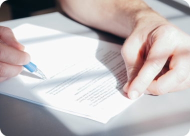A person writing on a piece of paper.