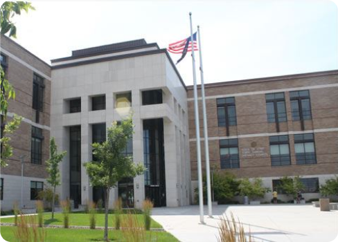 A flagpole in front of a building.