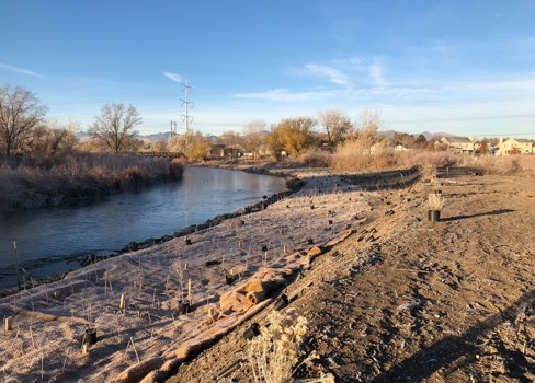 A river with a small bridge.