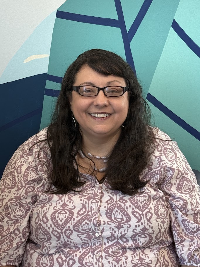 A woman smiling for the camera.