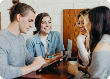 A group of people sitting around a table.