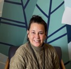 A man smiling in a chair.