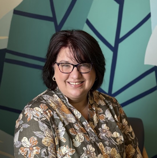 A woman smiling for the camera.