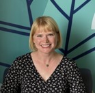 A woman smiling for the camera.