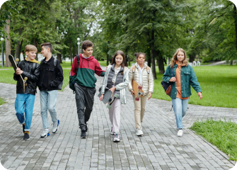 A group of people walking on a path in a park.