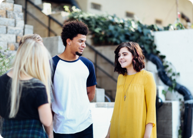 A group of people standing outside.