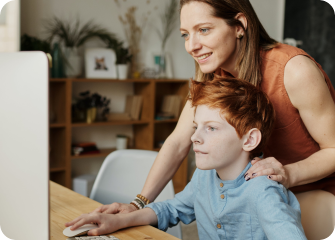 A person and a child looking at a computer.