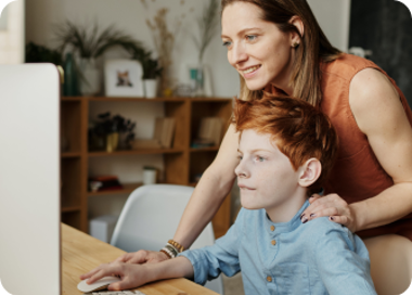 A person and a child looking at a computer.