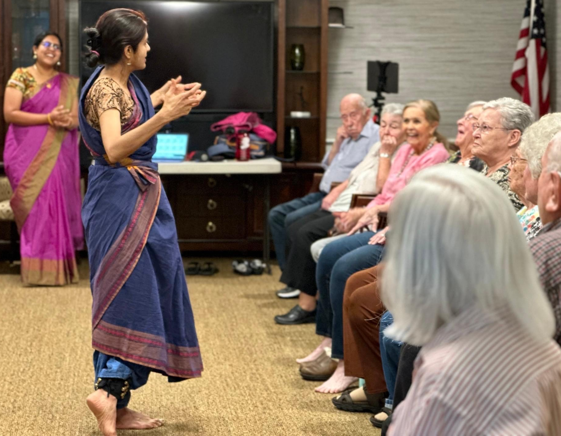 A woman speaking to an old woman.