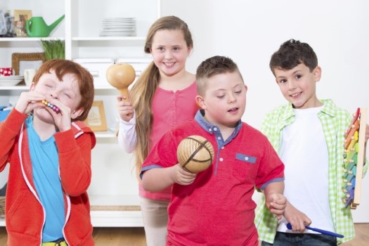 A group of kids holding a bowl.