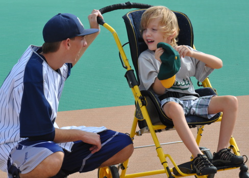 A person and a boy sitting in a chair.