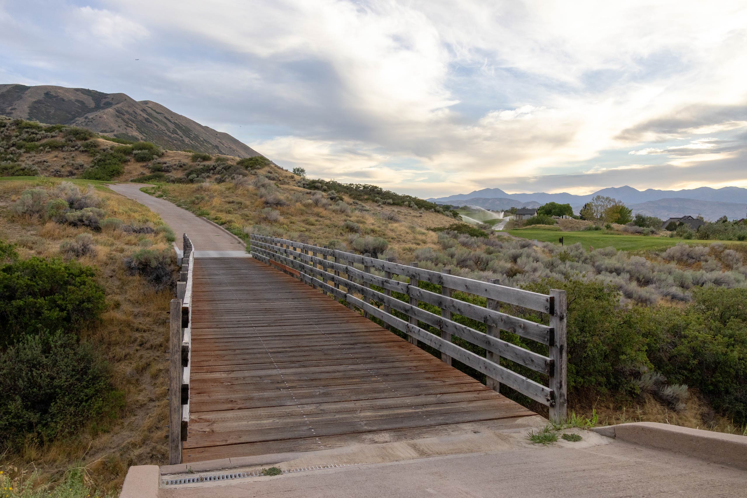 A wooden bridge connecting golf cart paths at South Mountain golf course in Salt Lake City.