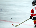 A kid playing hockey.