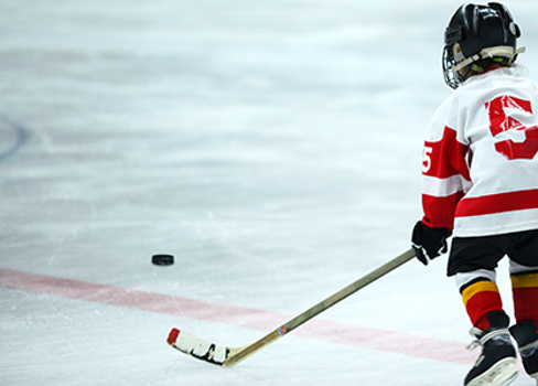 A kid playing hockey.