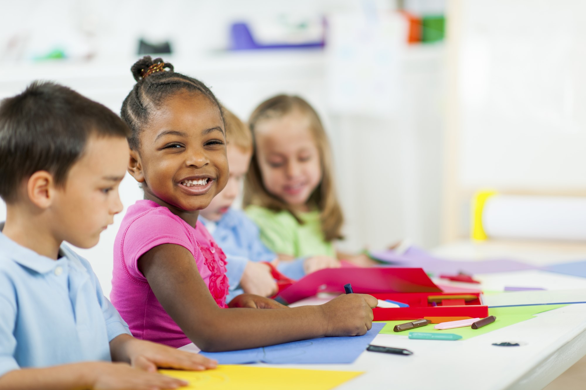 A group of children sitting at a table.