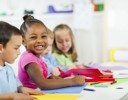 A group of children sitting at a table.