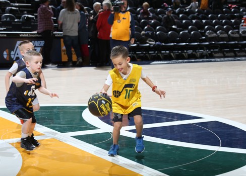 A couple of boys playing basketball.