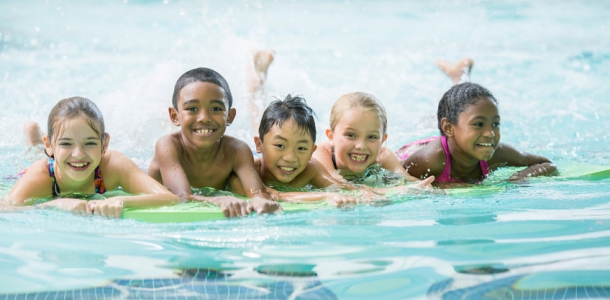 A group of kids in a swimming pool.